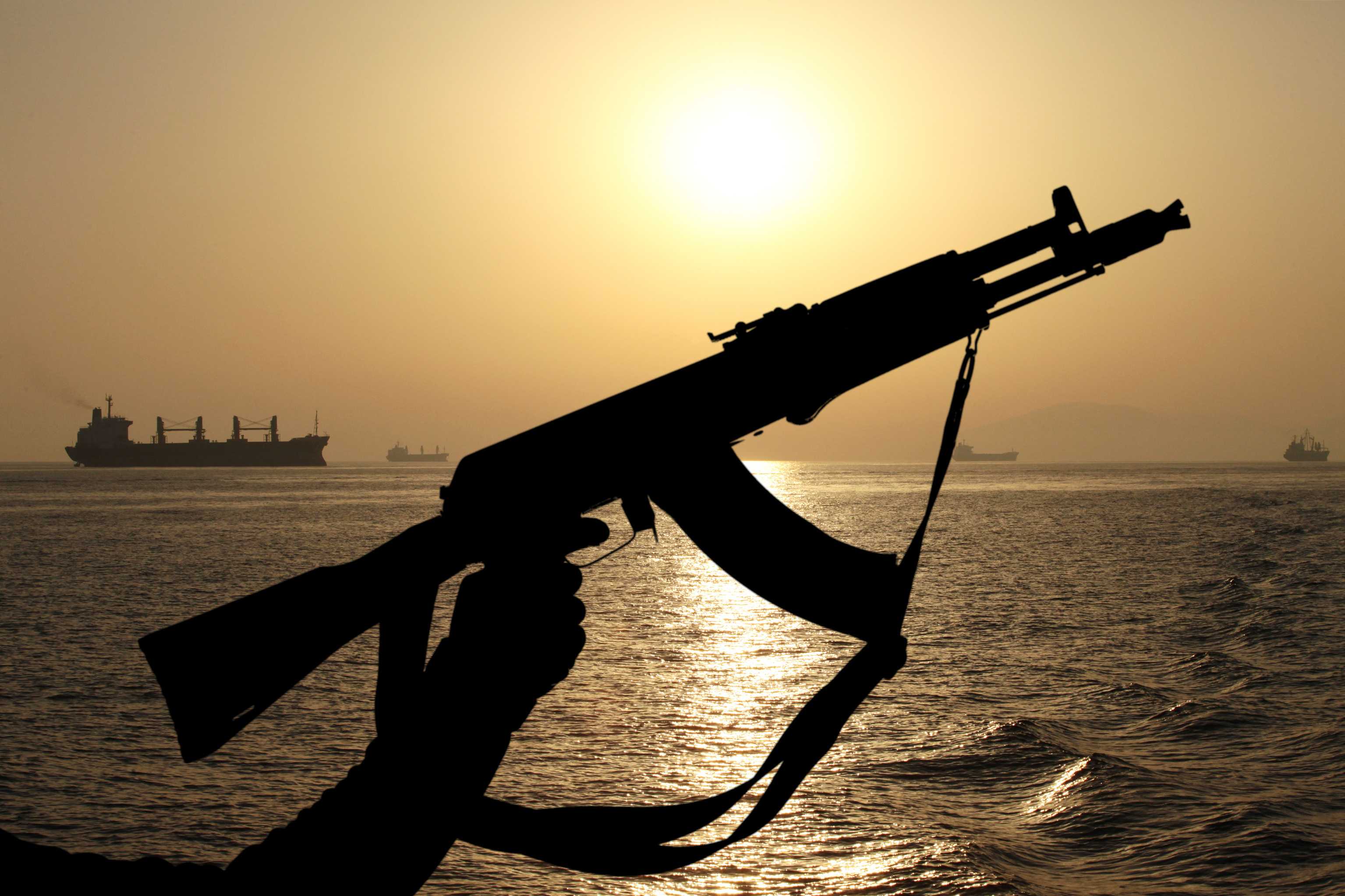 Pirate AK47 with ship in background Pirate AK47 with ship in background